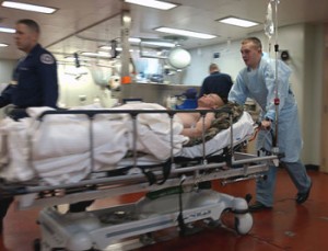 Hospital personnel wheel gurney